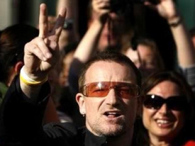 Bono, U2 frontman and universal good doer shows the sign of peace