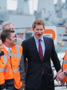 An animated Prince Harry meets workers at the site of the new Mary Rose Museum during a visit to the Mary Rose Museum in Portsmouth, United Kingdom on March 18, 2011 