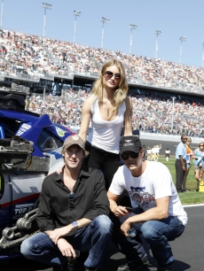 Director Michael Bay poses with “Transformers: Dark of the Moon” stars Josh Duhamel and Rosie Huntington-Whiteley pose before the Daytona 500 at Daytona International Speedway in Daytona Beach, Florida, on February 20, 2011  