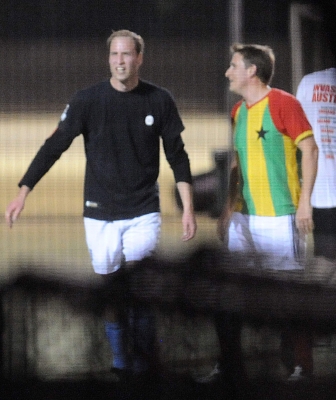 Prince William smiles while playing soccer in a South London park on April 26, 2011