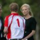 Prince Harry talks with Charlize Theron after playing in the Audi Polo Challenge polo match for team Sentebale versus team Audi at Coworth Park Polo Club in Ascot, England on May 8, 2011 