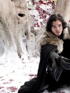 Jon Snow (Kit Harrington) kneels in the Godswoods as he takes his oath for the Knight’s Watch on “Game of Thrones,” HBO, 2011