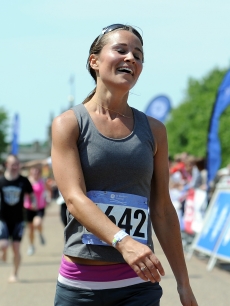 Pippa Middleton reacts after crossing the finish line during the GE Blenheim Triathlon at Blenheim Palace in Woodstock, England, on June 4, 2011