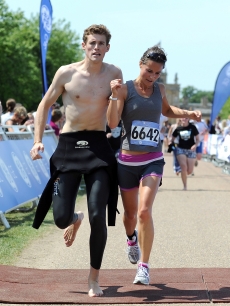 Pippa Middleton escapes a near collision with a fellow runner as she crosses the finish line during the GE Blenheim Triathlon at Blenheim Palace in Woodstock, England, on June 4, 2011
