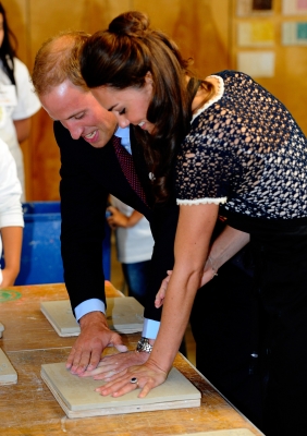 Prince William, Duke of Cambridge, and Catherine, Duchess of Cambridge smile while making hand prints in clay at Inner City Arts in Los Angeles on July 10, 2011 
