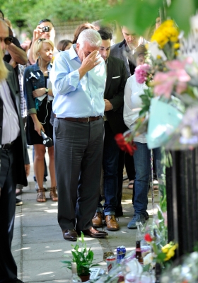 Amy Winehouse’s father, Mitch Winehouse, gets emotional as he looks at floral tributes left at her house by fans in London, England on July 25, 2011