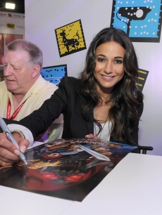 Emmanuelle Chriqui, who voices Cheetara, signs posters at a “Thundercats” event