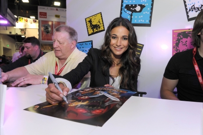 Emmanuelle Chriqui, who voices Cheetara, signs posters at a “Thundercats” event