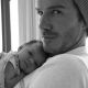 Harper Seven snuggles with daddy David Beckham in a photo posted on August 7, 2011