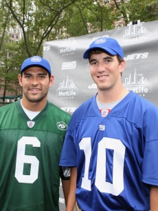 New York Jets quarterback Mark Sanchez and New York Giants quaterback Eli Manning pose during the MetLife Stadium celebration in Bryant Park, NYC, on August 26, 2011