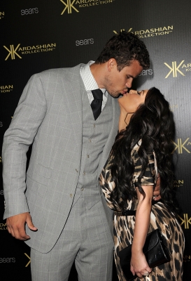 Kris Humphries and Kim Kardashian share a kiss on the red carpet of the Kardashian Kollection Launch Party in Hollywood, Calif.on August 17, 2011