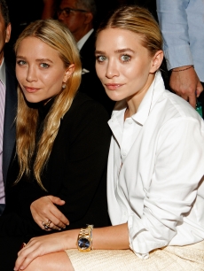 Mary-Kate Olsen and Ashley Olsen pose at FIJI Water at the J. Mendel Spring 2012 show during Mercedes-Benz Fashion Week in New York City on September 14, 2011
