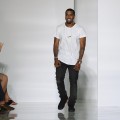 Kanye West acknowledges the applause of the audience after the KW by Kanye West Ready to Wear Spring / Summer 2012 show during Paris Fashion Week at Lycee Henri IV in Paris on October 1, 2011 