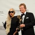 Lady Gaga stands with Nigel Lythgoe of Britain, ‘American Idol’ Executive Producer, after presenting him with The Founders Award at the 39th International Emmy Awards November 21, 2011