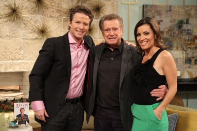 Regis Philbin poses with Billy Bush and Kit Hoover on Access Hollywood Live on November 30, 2011