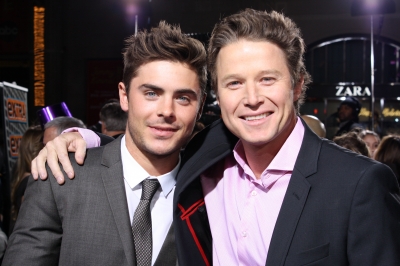 Zac Efron and Billy Bush hug it out on the red carpet at the ‘New Year’s Eve’ premiere in Hollywood on December 5, 2011