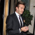 Dapper daddy David Beckham is spotted carrying baby Harper in London on December 31, 2011