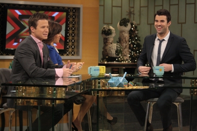 ‘X Factor’ host Steve Jones has a laugh with Billy Bush and Kit Hoover on the set of Access Hollywood Live on December 20, 2011