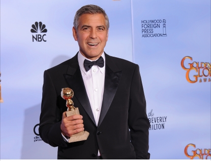 George Clooney poses with the trophy for Best Actor in a Motion Picture, Drama at the 69th annual Golden Globe Awards at the Beverly Hilton Hotel in Beverly Hills