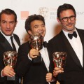 Jean Dujardin, Thomas Langmann and Michel Hazanavicius from the film ‘The Artist’ pose with their awards in the press room with the Best Actor award during the Orange British Academy Film Awards 2012 at the Royal Opera House on February 12, 2012 in London