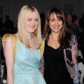 Dakota Fanning and Natalie Portman smile at the Rodarte Fall 2012 fashion show during Mercedes-Benz Fashion Week at the Metropolitan Pavilion in New York City on February 14, 2012