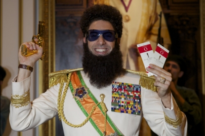 Sacha Baron Cohen (as ‘The Dictator’ Admiral General Aladeen) shows off a golden gun and Oscar tickets on February 24, 2012 