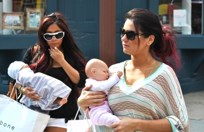 Nicole ‘Snooki’ Polizzi and Jenni ‘JWoww’ Farley cradle their baby dolls, seen on location for ‘Snooki and JWoww vs. the World’ in Jersey City, NJ, on March 23, 2012