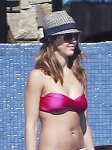 Jessica Alba shows off her post-baby body while spending the day poolside with husband Cash Warren and their daughters Haven and Honor in Cabo San Lucas, Mexico in December 2011