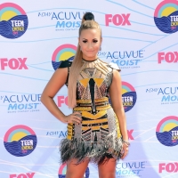 Demi Lovato arrives in a daring mesh Falguni & Shane dress with metallic embellishments at the 2012 Teen Choice Awards at Gibson Amphitheatre in Universal City, Calif., on July 22, 2012