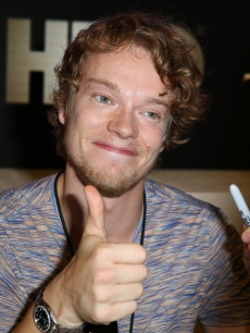 Alfie Allen gives the thumbs up as he signs autographs for HBO’s ‘Game Of Thrones’ during Comic-Con International 2012 at San Diego Convention Center on July 13, 2012