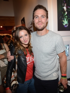 Stephen Amell (R) and Katie Cassidy attend DC Entertainment hosts ‘Darkness & Light’ party at San Diego Comic-Con International benefitting We Can Be Heroes held at Michael J. Wolf Fine Arts Gallery on July 12, 2012