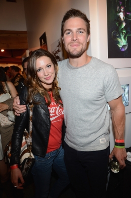 Stephen Amell (R) and Katie Cassidy attend DC Entertainment hosts ‘Darkness & Light’ party at San Diego Comic-Con International benefitting We Can Be Heroes held at Michael J. Wolf Fine Arts Gallery on July 12, 2012
