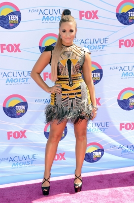 Demi Lovato arrives in a daring mesh Falguni & Shane dress with metallic embellishments at the 2012 Teen Choice Awards at Gibson Amphitheatre in Universal City, Calif., on July 22, 2012