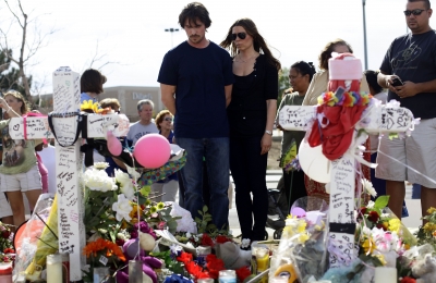 Christian Bale and his wife Sandra Blazic pay their respects at the memorial across the street from the Century 16 movie theater in Aurora, Colorado on July 24, 2012