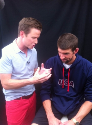 Billy Bush and U.S. swimmer Michael Phelps chat together at the 2012 Summer London Olympics on July 25, 2012