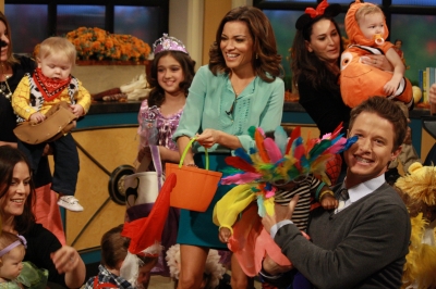 Billy Bush and Kit Hoover pose with some of the kids and the parents who took part in the Access Hollywood Live Halloween kids costume show