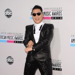 Psy shows off some Gangman style dance moves as he walks the red carpet of the 40th American Music Awards at Nokia Theatre on November 18, 2012 in Los Angeles