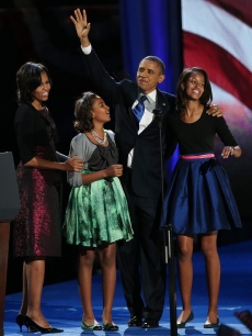 President Barack Obama walks on stage with first lady Michelle Obama and daughters Sasha and Malia to deliver his victory speech on election night at McCormick Place November 6, 2012 in Chicago