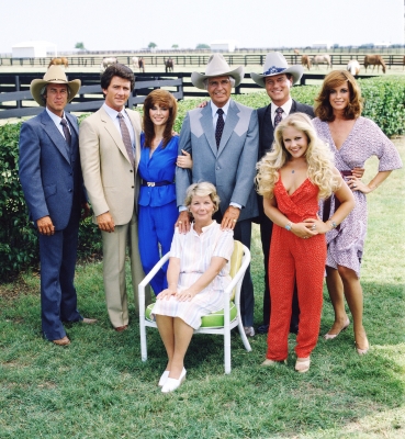 A promotional still from the American television series ‘Dallas’ shows the cast assembled on the property of the Southfork ranch, on the outskirts of Dallas, Texas, 1979. From left, American actors Steve Kanaly (as Ray Krebbs), Patrick Duffy (as Bobby Ewing), Victoria Principal (as Pamels Barnes Ewing), (sitting), Barbara Bel Geddes (as Eleanor Southworth ‘Miss Ellie’ Ewing), Jim Davis (1909 - 1981) (as John Ross ‘Jock’ Ewing), Larry Hagman (as John Ross ‘J.R.’ Ewing, Jr.), Charlene Tilton (as Lucy Ewing) (in red), and Linda Gray (as Sue Ellen Ewing)
