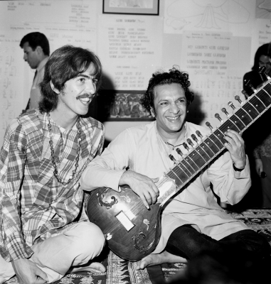 Guitarist George Harrison poses for a portrait with Indian sitar virtuoso Ravi Shankar in circa 1975