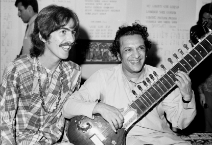 Guitarist George Harrison poses for a portrait with Indian sitar virtuoso Ravi Shankar in circa 1975