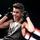 Justin Bieber shows off his guns while onstage during Hot 99.5’s Jingle Ball 2012 on December 11, 2012 in Washington, D.C. 