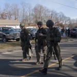 Connecticut State Police walk near the scene of an elementary school shooting on December 14, 2012 in Newtown, Connecticut