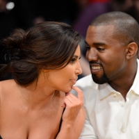 Kim Kardashian and rapper Kanye West talk from their courtside seats before the Los Angeles Lakers take on the Denver Nuggets in Game Seven of the Western Conference Quarterfinals in the 2012 NBA Playoffs on May 12, 2012 at Staples Center in Los Angeles