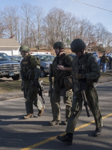 Connecticut State Police walk near the scene of an elementary school shooting on December 14, 2012 in Newtown, Connecticut