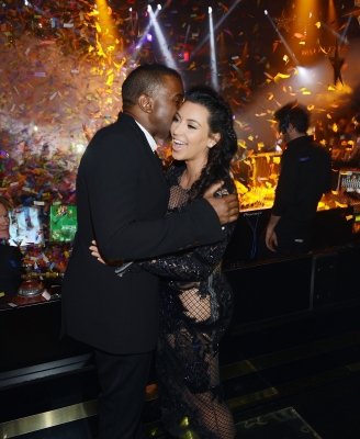 Kanye West plants a kiss on Kim Kardashian inside Mirage’s 1 OAK nightclub as the clock hits midnight on December 31, 2012