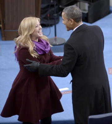 President Barack Obama greets singer Kelly Clarkson after Obama took the oath of office during the 57th Presidential Inauguration ceremonial swearing-in at the US Capitol on January 21, 2013 in Washington, DC