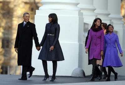 President Barack Obama and First Lady Michelle Obama are joined by their daughters Sasha and Malia at the White House as they walk to the reviewing stand for the inaugural parade on January 21, 2013 in Washington,DC