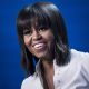 First Lady Michelle Obama smile while speaking during the Kids’ Inaugural concert at the Washington Convention Center January 19, 2013 in Washington, DC