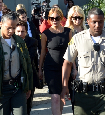 Lindsay Lohan her lawyer Mark Heller and her mother Dina leave Airport Courthouse after the pre-trial hearing on January 30, 2013 in Los Angeles

